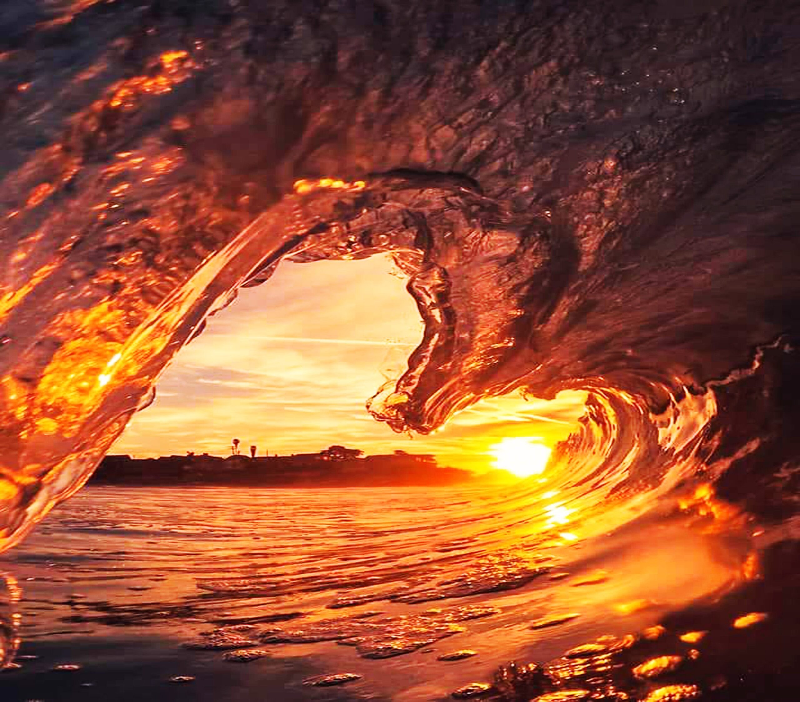 sunset through a heart-shaped wave